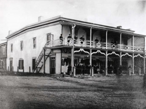 The Johnson Building (circa 1872) at the northeast corner of the Plaza that housed the Signal Service office Nov 18, 1871 – Jun 28, 1873 and Mar 26, 1878 – Mar 1, 1882. View is looking southeast with Washington Avenue to the left and the Plaza to the right. From the Palace of the Governors Angelico Chavez History Library in Santa Fe.